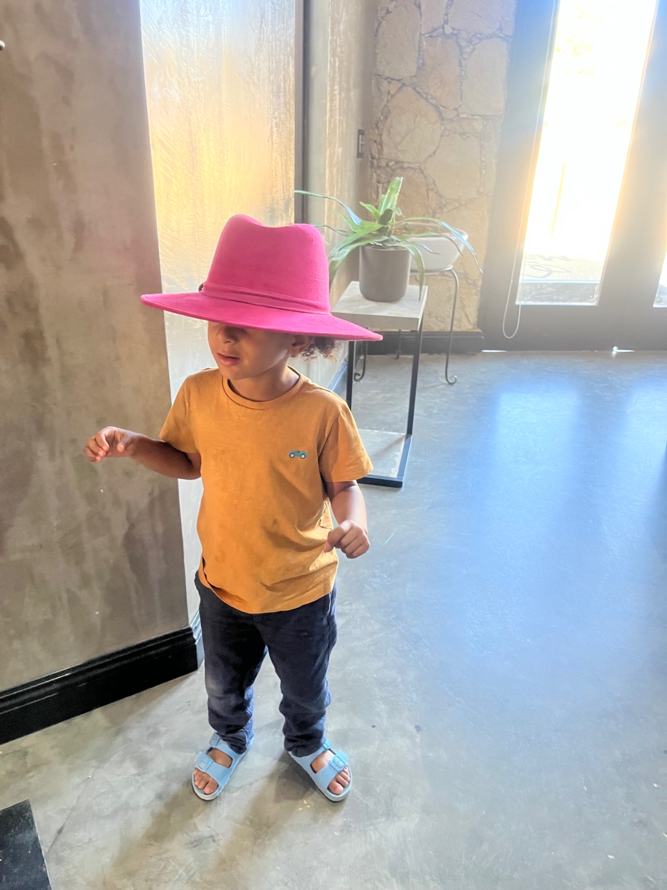Child in a bright pink hat in the Valle.