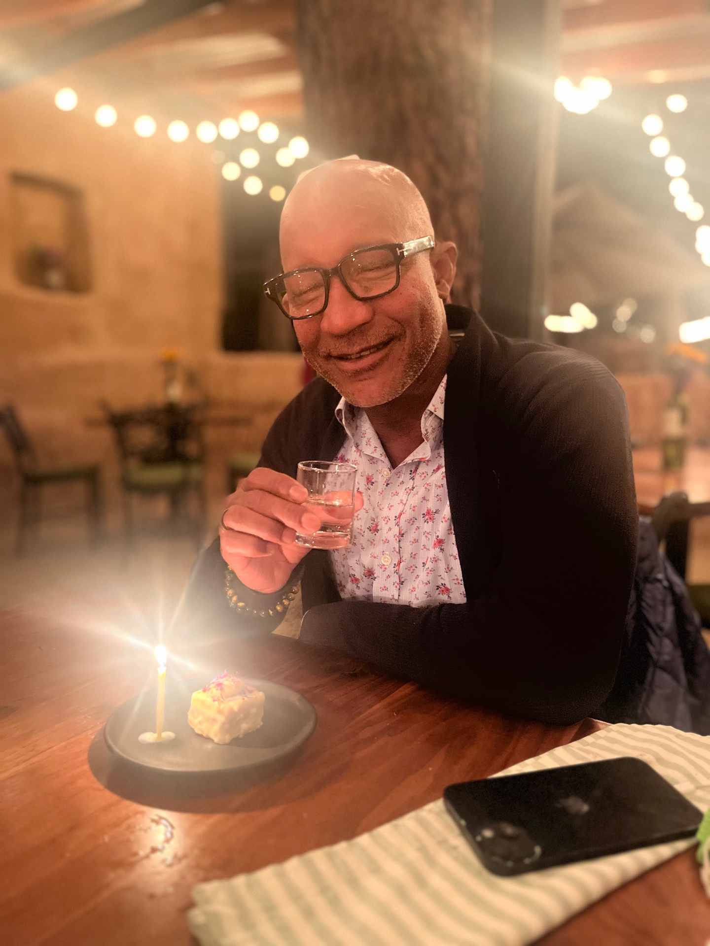 Birthday toast with a glass and a candle at a Valle restaurant.