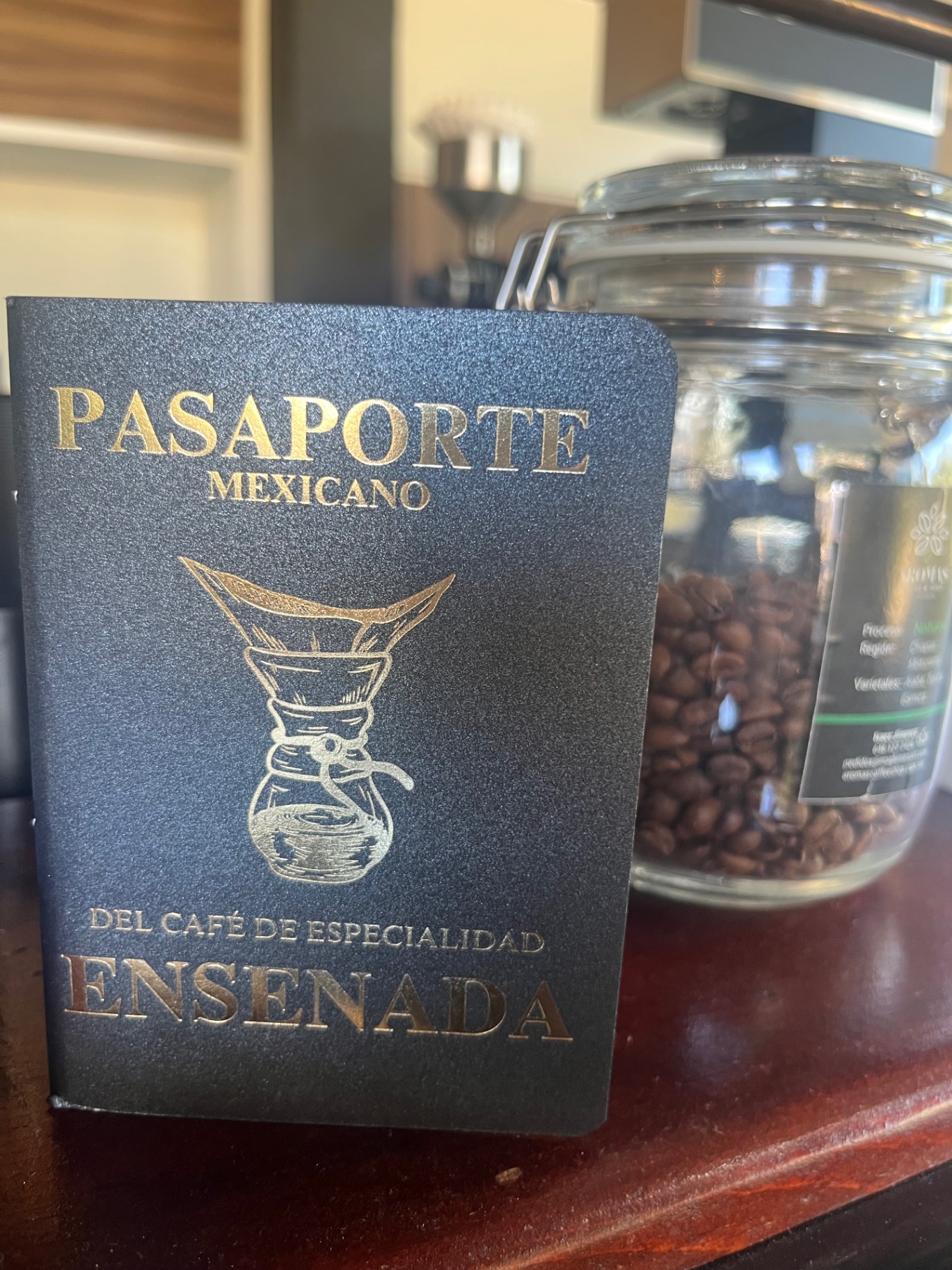 Ensenada specialty passport beside a jar of roasted beans.
