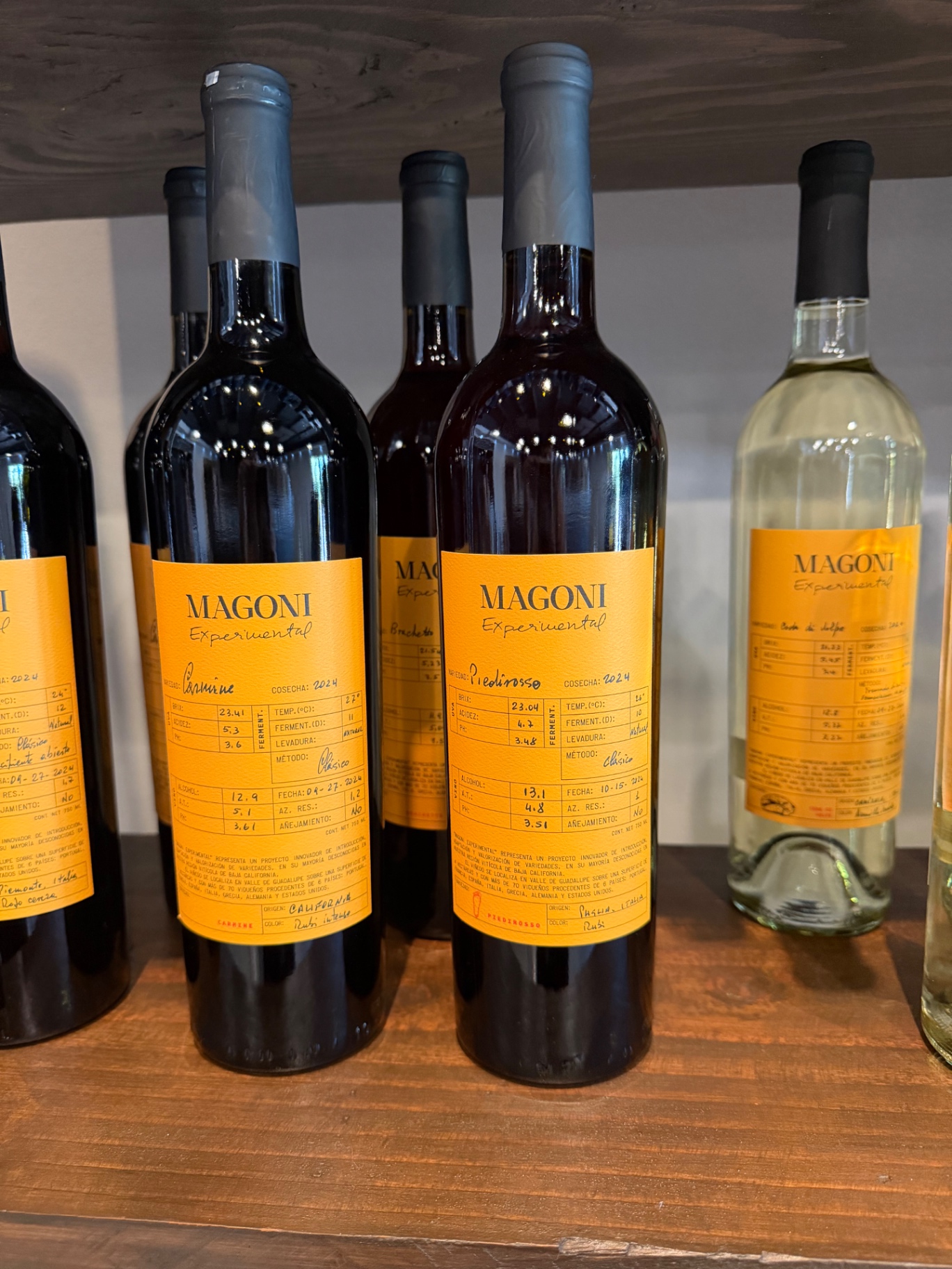 Magoni Experimental bottles with handwritten ochre labels.