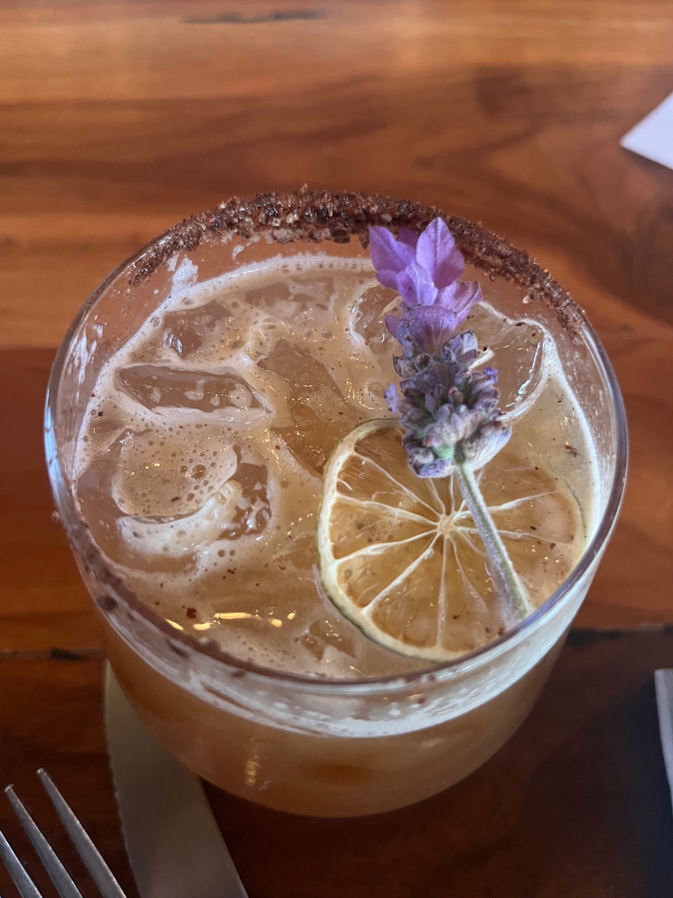 Cocktail with lavender and dried lime, worm-salt rim.